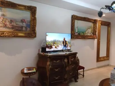 a living room with a tv on top of a dresser at Zineb in Nouaseur