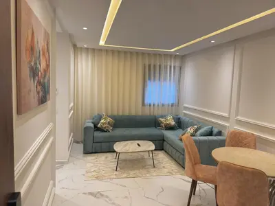 a living room with a couch and a table at Appartement chic Rabat in Rabat