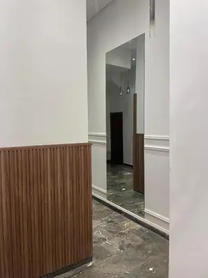 a hallway with wood panels and a mirror at Appartement chic Rabat in Rabat