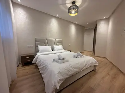 a bedroom with a large bed with two stuffed animals on it at Appartement chic Rabat in Rabat