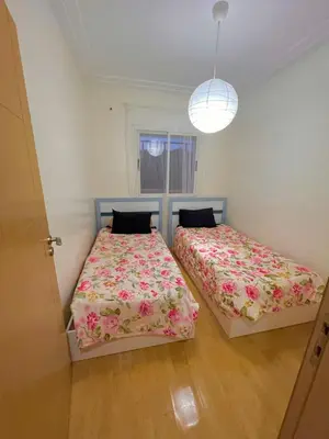 a bedroom with two beds and a window at Appartement Cosy & Calme avec Piscine, Tamaris Dar Bouazza in Tamaris