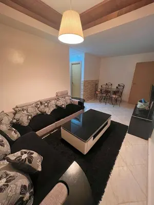 a living room with a couch and a coffee table at Appartement Cosy & Calme avec Piscine, Tamaris Dar Bouazza in Tamaris