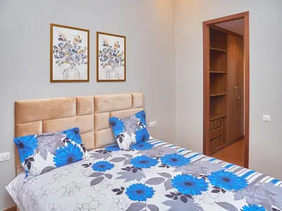 a bedroom with a bed with blue and gray pillows at Appartement haut standing in Casablanca