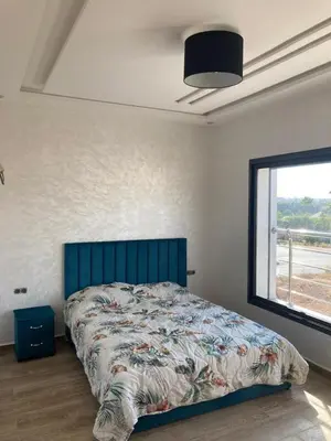 a bedroom with a bed with a large window at Villa oued cherrat bouznika 3 bedrooms in Bouznika