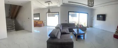 a living room with a couch and a table at Villa oued cherrat bouznika 3 bedrooms in Bouznika