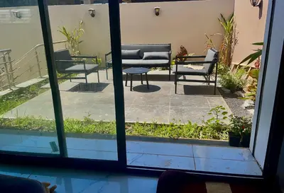 a window view of a patio with chairs and a table at Villa oued cherrat bouznika 3 bedrooms in Bouznika