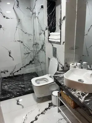 a black and white bathroom with a toilet and a sink at Cosy Studio Plein Casablanca in Casablanca