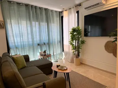 a living room with a couch and a table at Cosy Studio Plein Casablanca in Casablanca