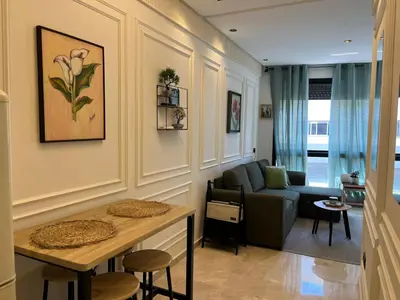 a living room with a couch and a table at Cosy Studio Plein Casablanca in Casablanca