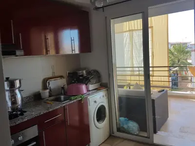 a kitchen with a washing machine and a sink at Berrada in Dar Mohammed Ould Haj Jilali