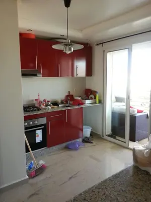 a kitchen is being remodeled with red cabinets at Berrada in Dar Mohammed Ould Haj Jilali