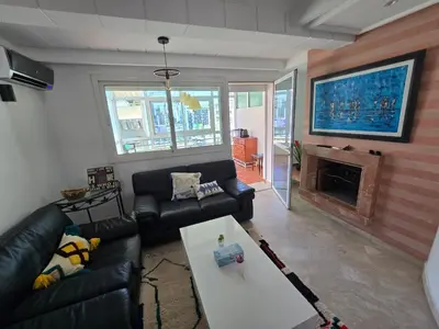a living room with a couch and a fireplace at Appartement cosy en plein quartier d'affaires in Casablanca