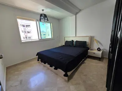 a bedroom with a bed and a window at Appartement cosy en plein quartier d'affaires in Casablanca