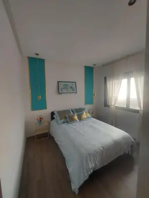 a bedroom with a large bed and a window at Duplex de Luxe avec Vue Mer a Zenata City-Eco in Aïn Harrouda