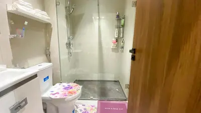 a bathroom with a shower and a toilet and a sink at Résidence luxueuse avec 5 Piscine A MANSOURIA près de la Mer in O Ben Slimane
