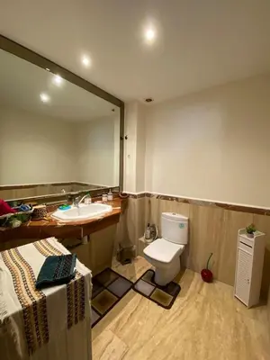 a bathroom with a sink and a toilet and a mirror at Élégance Océanique in Casablanca