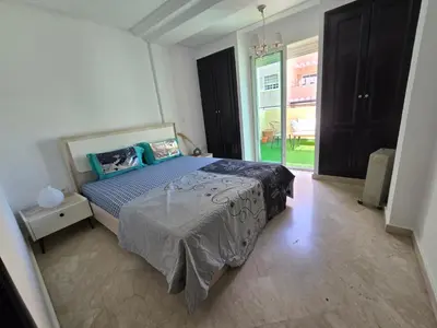 a bedroom with a bed and a glass door at Appartement cosy au centre de casablanca in Casablanca