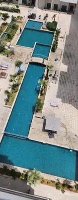 an overhead view of a row of swimming pools at Ocean park , for married couples and families only , Luxury fully furnished one bedroom flat next to zenata beach with five avialable swimming pool at the compound in Casablanca
