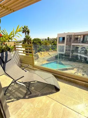 a patio with a chair and a swimming pool at Casa Tina in Casablanca