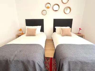 two beds in a room with mirrors on the wall at Casa Sahifa in Casablanca