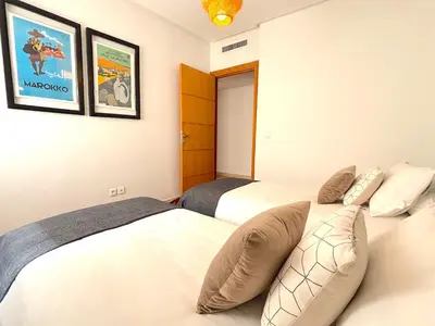 a bedroom with two beds and a couch at Casa Sahifa in Casablanca