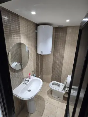 a bathroom with a sink and a toilet and a mirror at Appartement cosy au centre de Casablanca in Casablanca