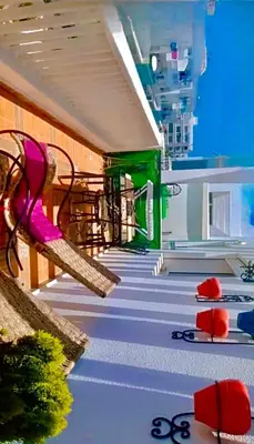 a hospital hallway with a pink chair and stairs at Appart avec piscine in Pont Blondin