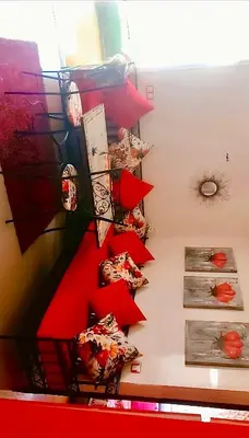 a room with red shelves with food on them at Appart avec piscine in Pont Blondin