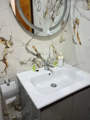 a bathroom with a white sink and a mirror at Élégance et Confort à Proximité de la Plage in Bouznika