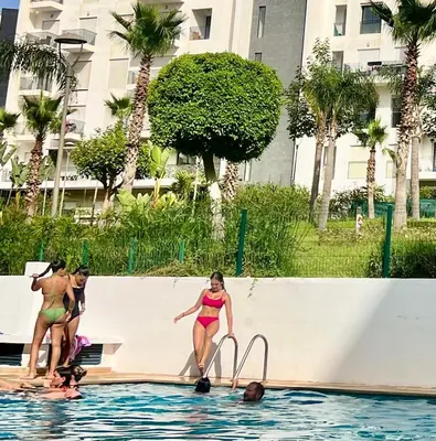 a group of women in the water at a swimming pool at appart luxueuse a rabat hay riad avec piscine in Rabat
