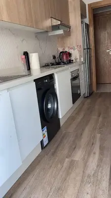 a kitchen with a washing machine in a counter top at Two bedroom Apartment in Bouznika Beach in Bouznika