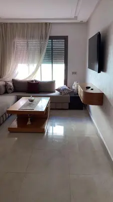 a living room with a couch and a table at Two bedroom Apartment in Bouznika Beach in Bouznika