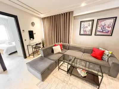 a living room with a couch and a table at Stylish 1BR in Racine - Prime Racine Location in Casablanca