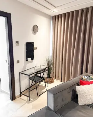 a living room with a couch and a glass table at Stylish 1BR in Racine - Prime Racine Location in Casablanca