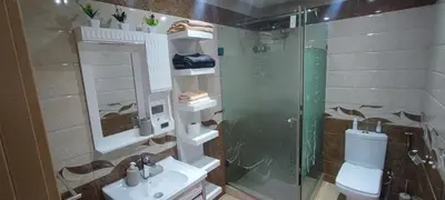 a bathroom with a shower and a toilet and a sink at Confort & Style à Mohammedia parc in Mohammedia