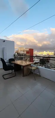 a table and chairs on top of a roof at Appartement à côté de mosquée Hassan 2 et marina shopping in Casablanca