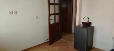 a hallway with a door and a small refrigerator at Appartement aéroport Mohammed 5 in Deroua