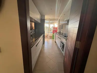 a kitchen with a long hallway with a sink and a stove at Appartement Bouznika Bay Golf Beach in Bouznika