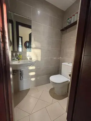 a bathroom with a toilet and a sink at Appartement Bouznika Bay Golf Beach in Bouznika