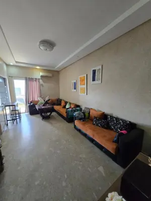 a living room with couches and chairs in a room at Les perle de tamaris in Dar Mohammed Ould Haj Jilali