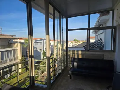 a view of a balcony with a couch and windows at Les perle de tamaris in Dar Mohammed Ould Haj Jilali