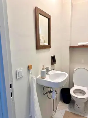 a bathroom with a sink and a toilet and a mirror at Cozy Stay with Hassan Tower View in Rabat