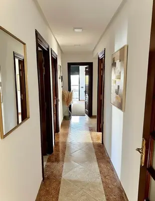 a hallway with white walls and a tile floor at Grand Appartement à Louer à Agdal, à Deux Pas de la Gare in Rabat
