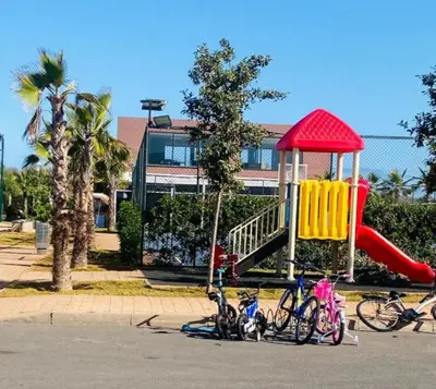 a group of bikes parked in front of a playground at Blue Beach Residence Balnéaire pour familles in Sidi Rahal