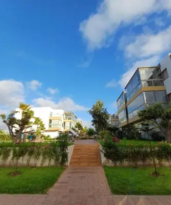 a brick walkway in front of a building at Blue Beach Residence Balnéaire pour familles in Sidi Rahal