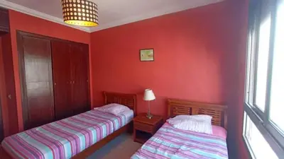 two beds in a room with red walls at Appartement moderne proche de la plage avec piscine in Skhirat