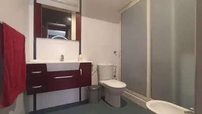 a bathroom with a toilet and a sink and a mirror at Appartement moderne proche de la plage avec piscine in Skhirat