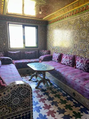 a living room with a couch and a table at Séjour cosy à Palm Beach Mansouriah in Pont Blondin