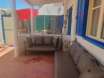 a porch with a couch and a window at Villa plage david in Kasba Bou Hamira