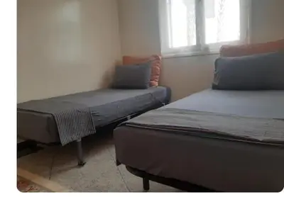 a room with two beds and a window at Villa plage david in Kasba Bou Hamira